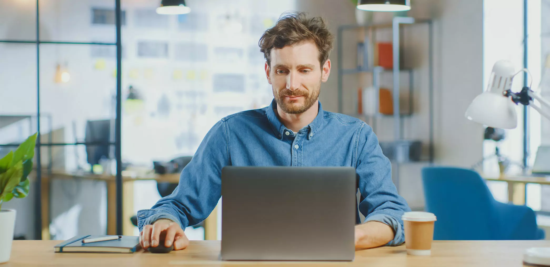 Man sitting at desk with laptop on an office.